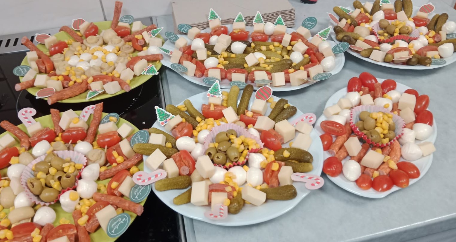 Kolorowe koreczki warzywne z serem, oliwkami i warzywami ułożone na talerzach podczas warsztatów sylwestrowych dla seniorów.